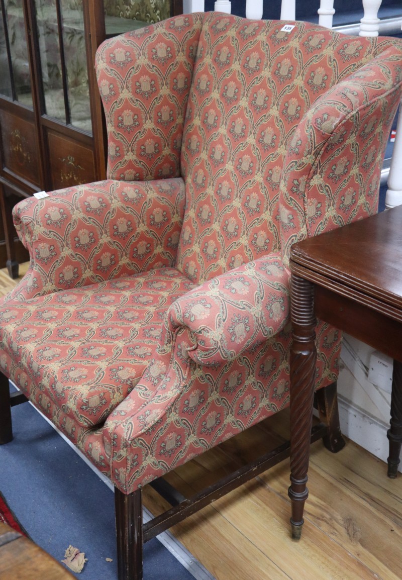 A George III style mahogany framed wing armchair